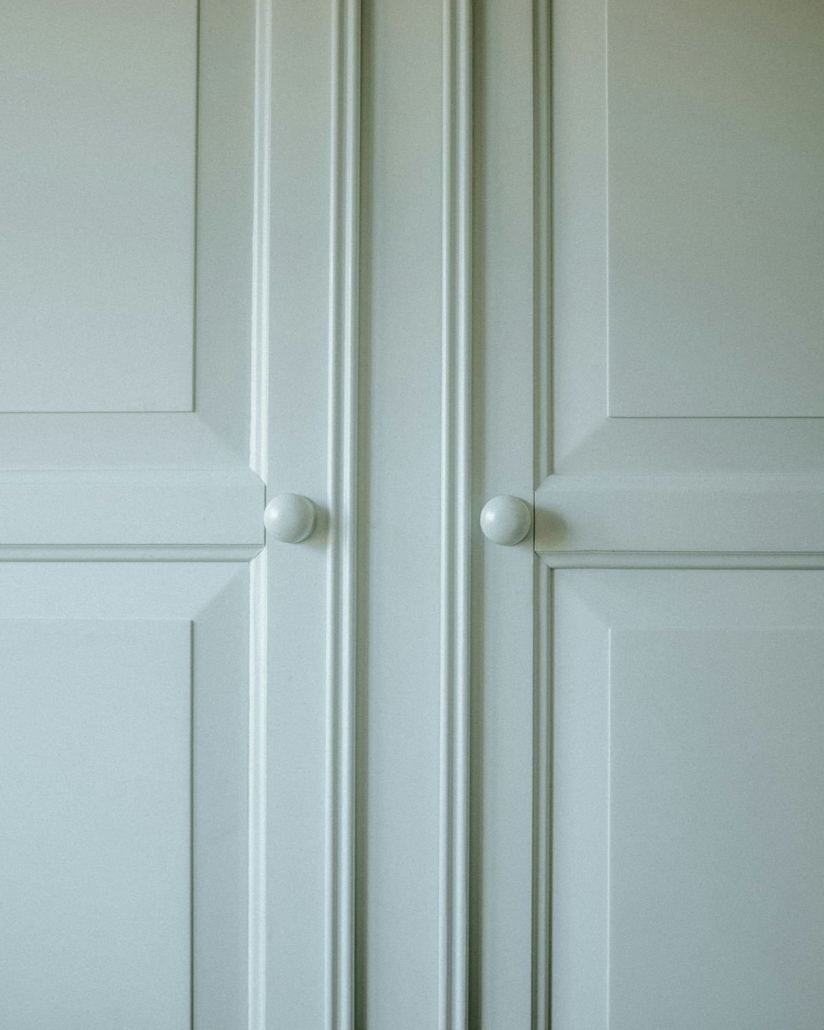 Close view of painted panelled doors showing an even, mark free finish.