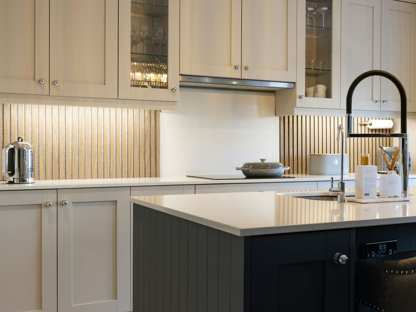 A shaker kitchen in bone white with a dark painted island bench.