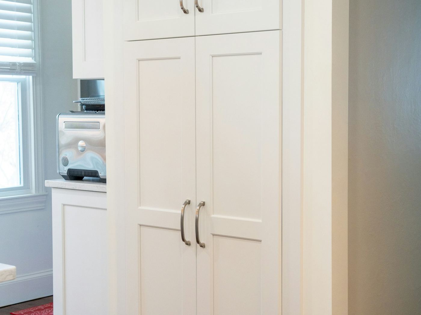Tall white cabinetry built into a hallway.
